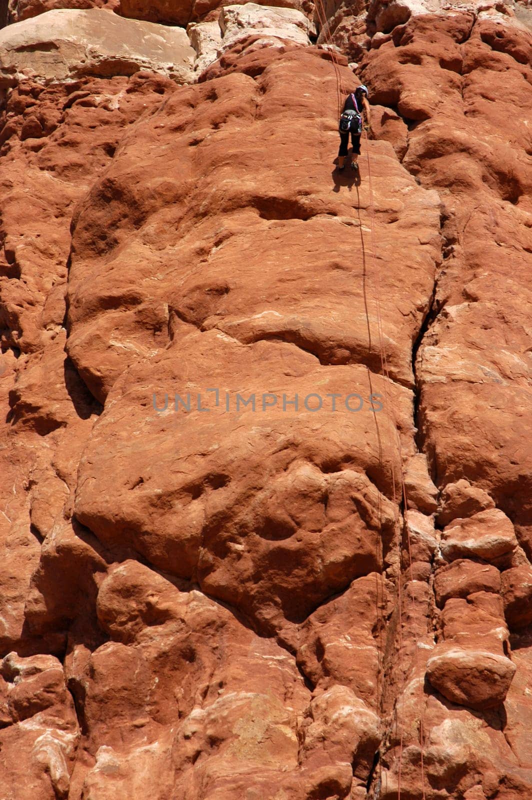 Woman rapelling off a desert tower