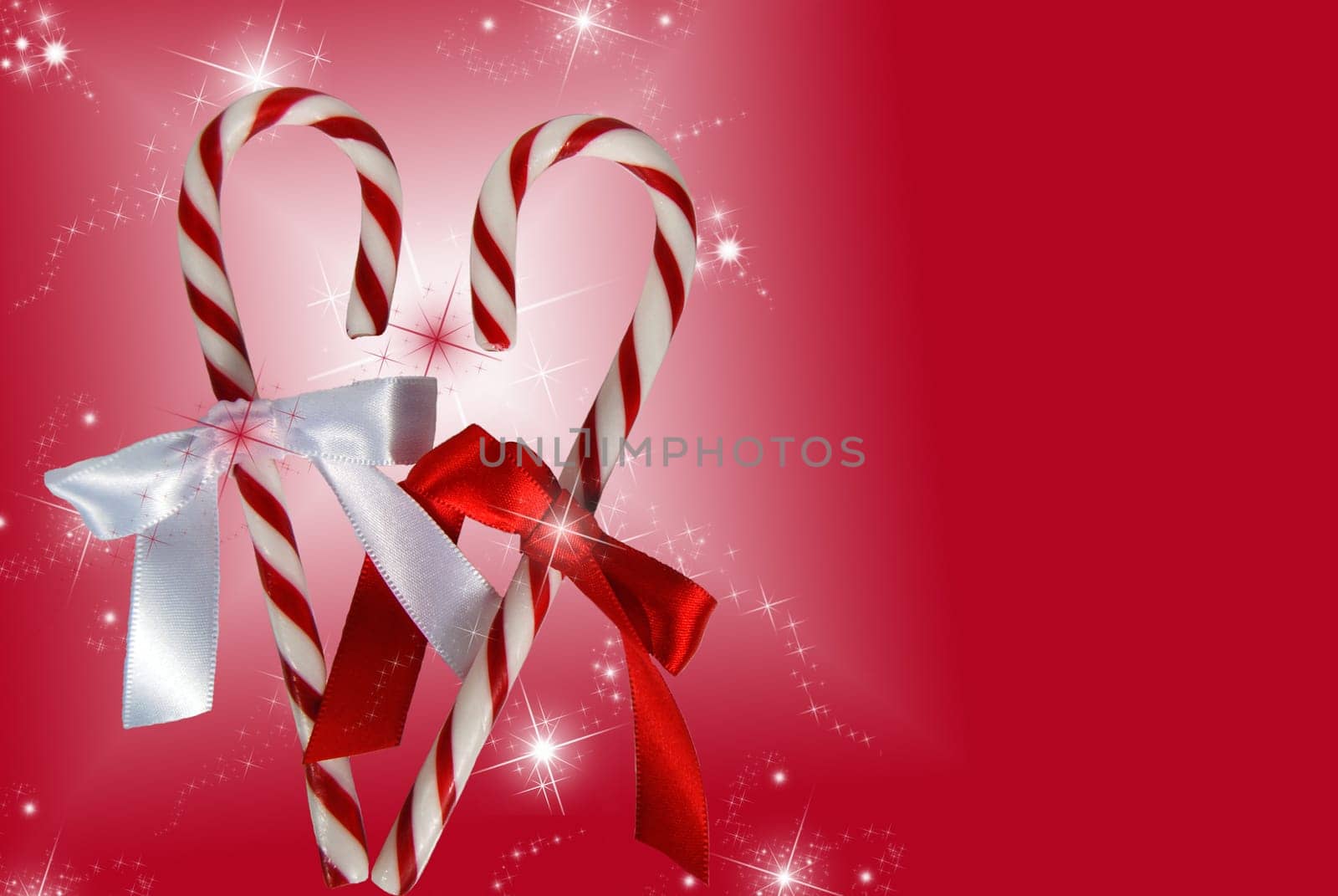 Pair of candy canes formed into a heart on a festive background.
