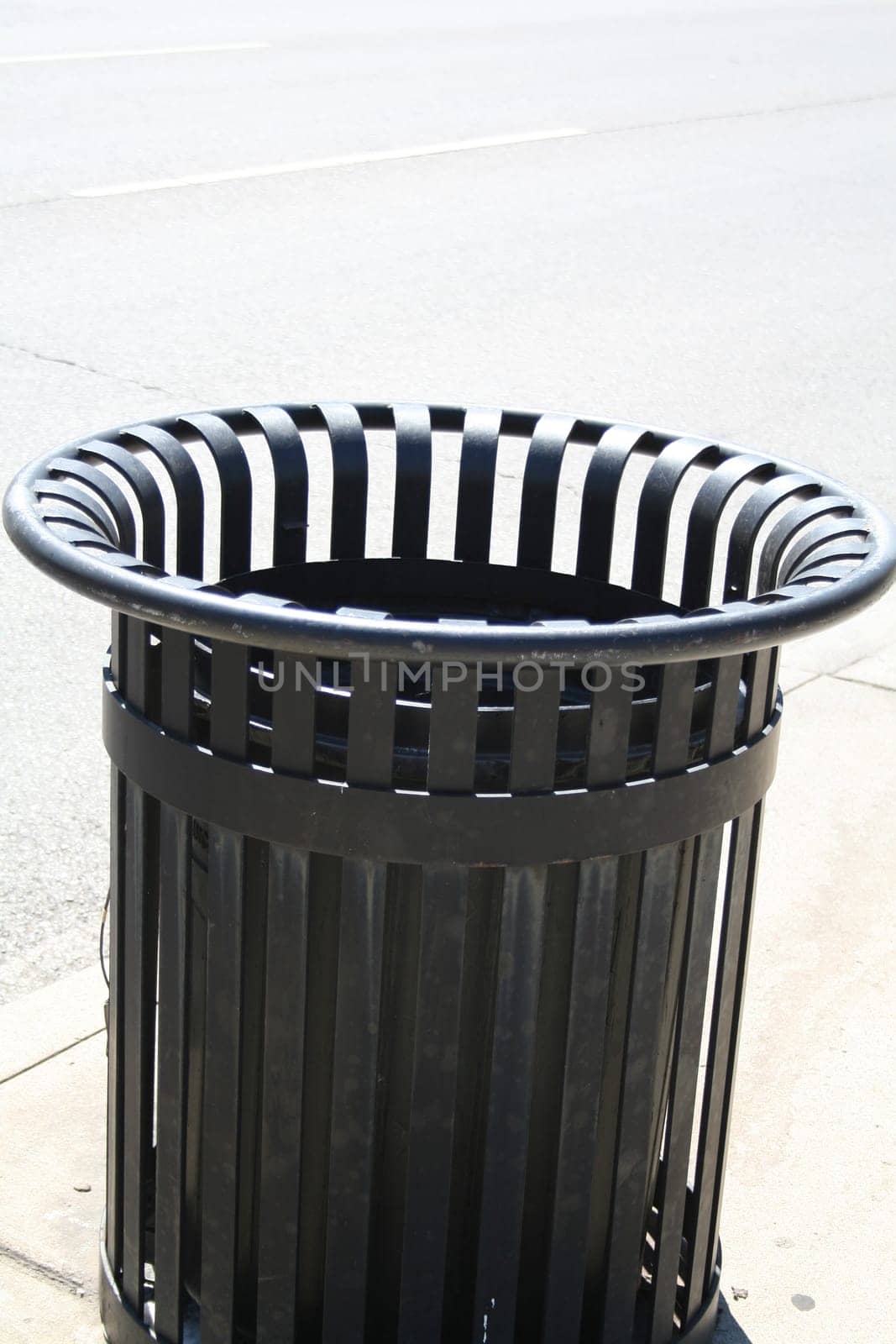 striped garbage can in the street