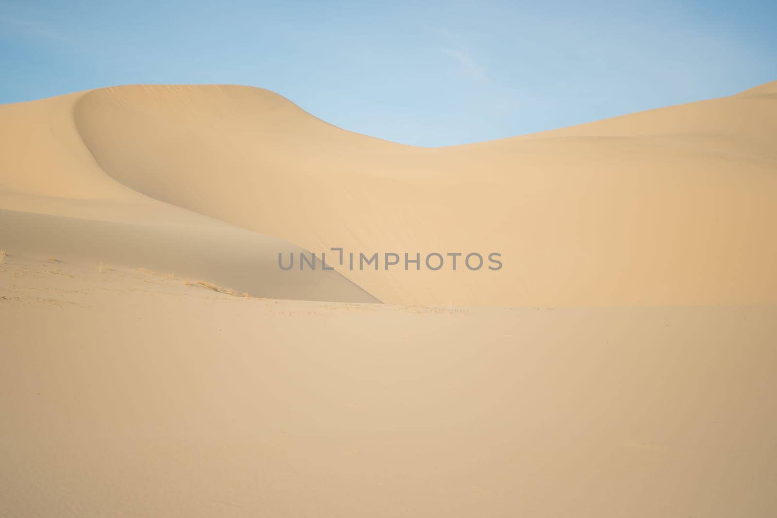 Sandy dune against a blue sky