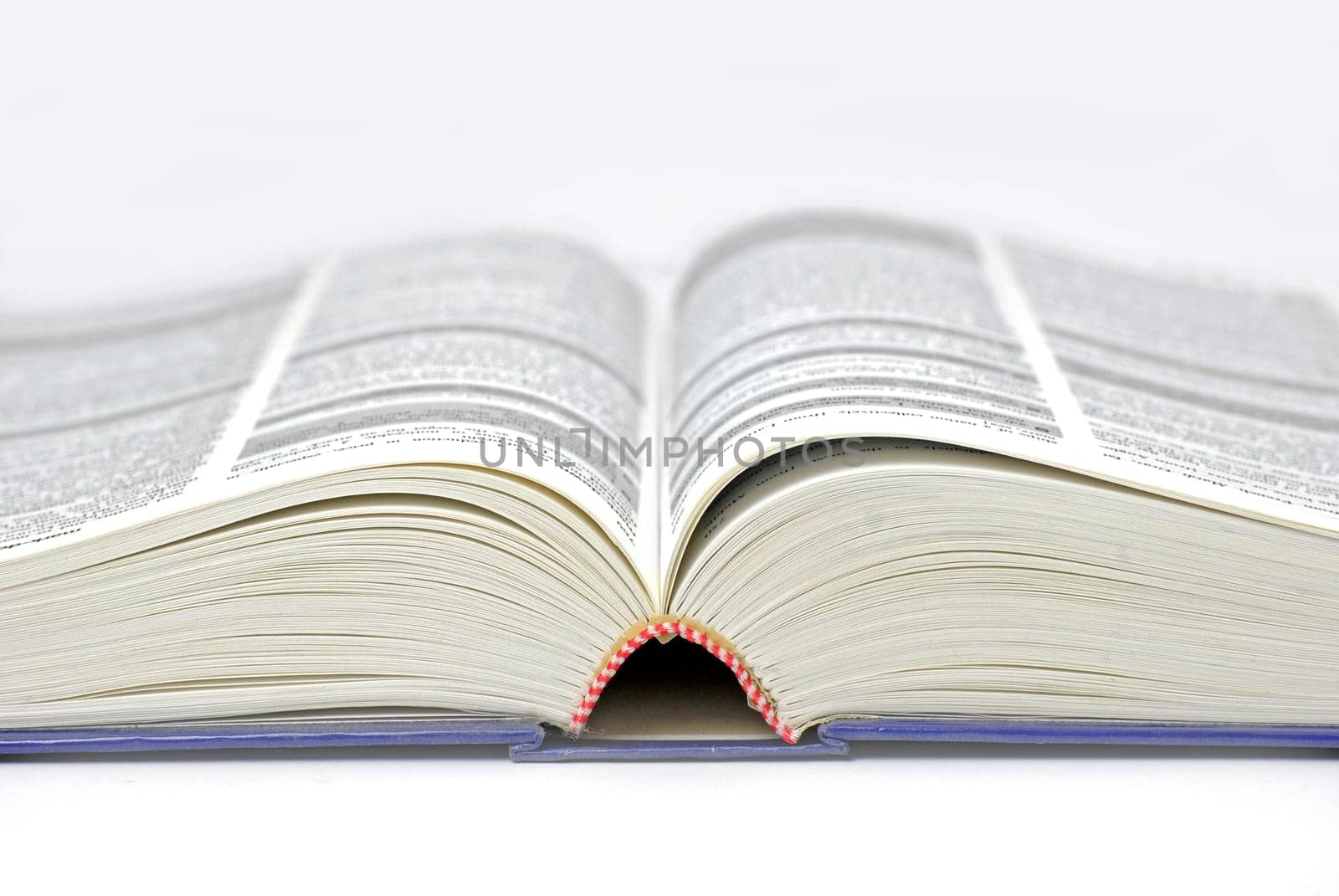 text/reference book lying open  text mostly illegible due to differential focus