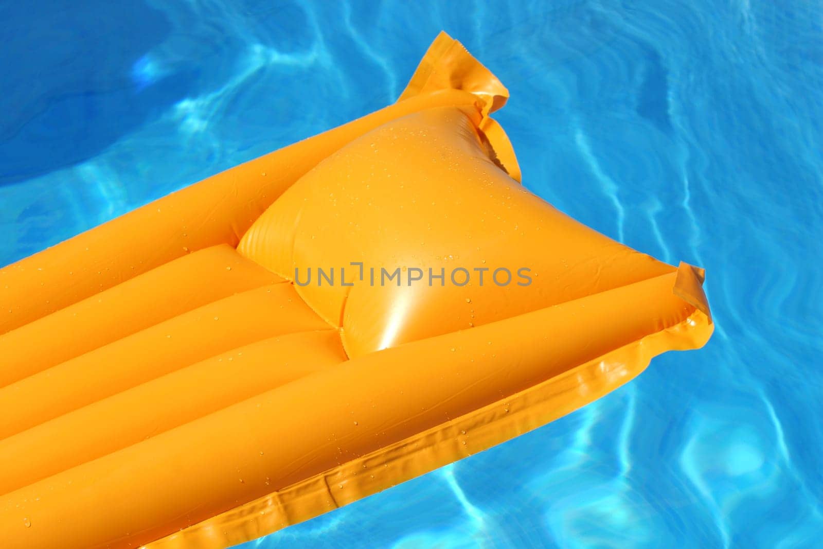 yellow airbed floating in bright blue water