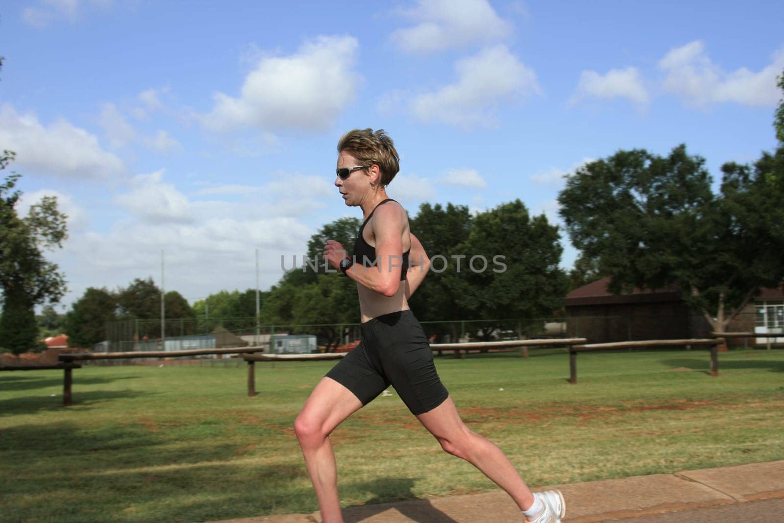 Female marathon champion training in the park.