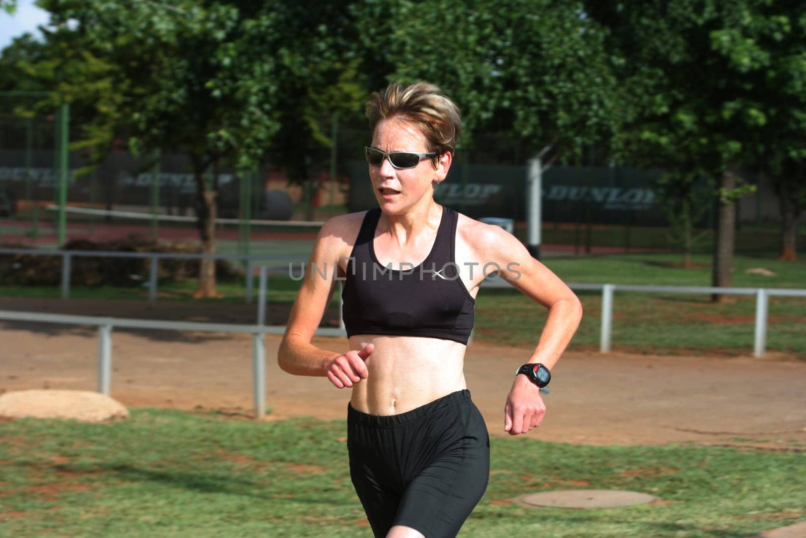 Female marathon champion training in the park.