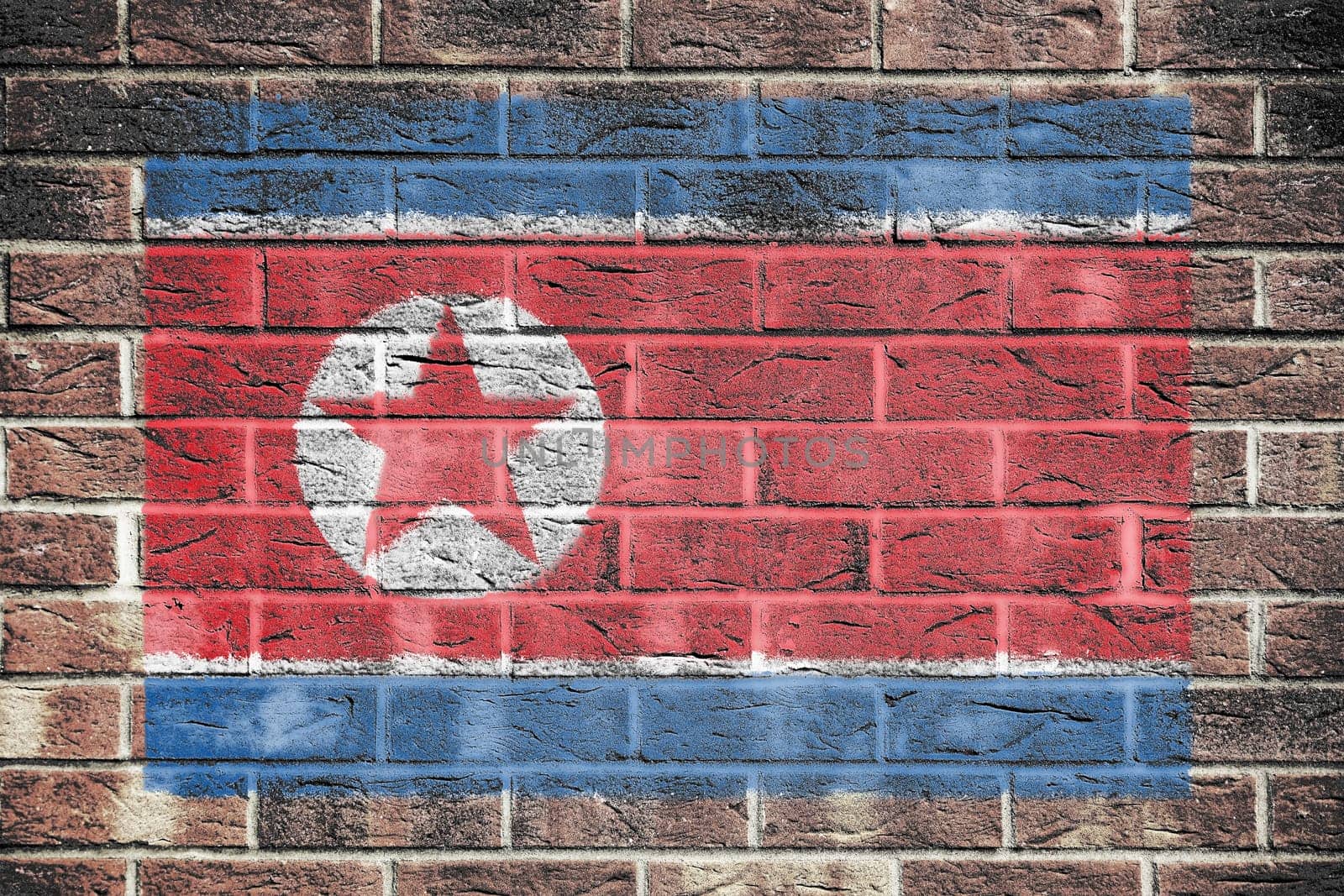 A North Korea flag on old brick wall background