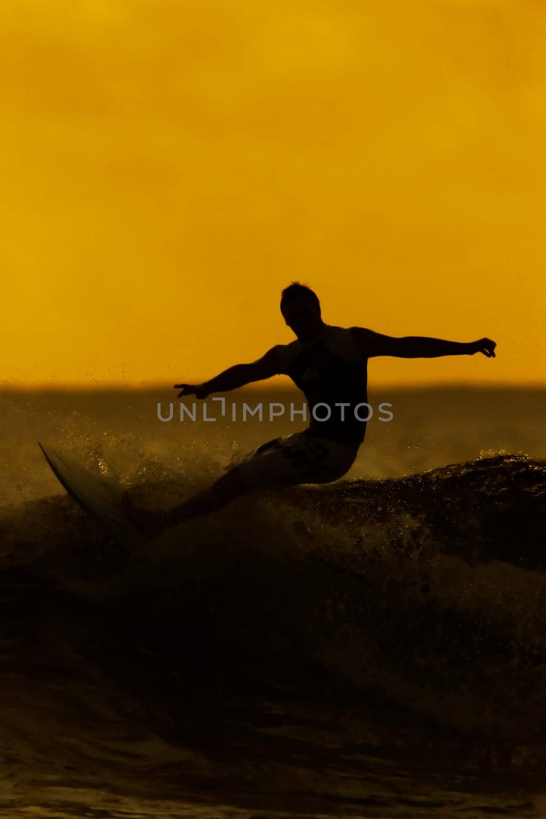 man surfing at sunset