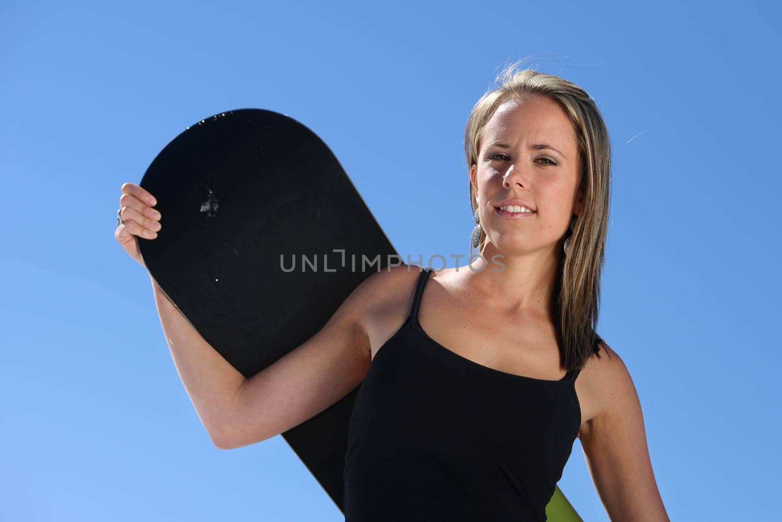 young sexy girl standing with a snowboard