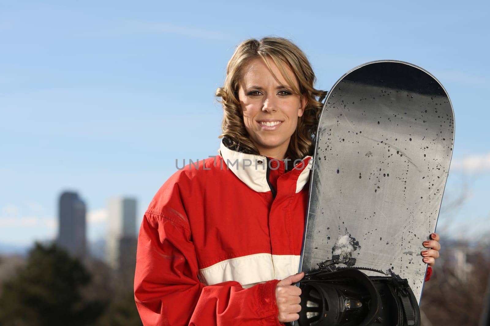 young sexy girl standing with a snowboard