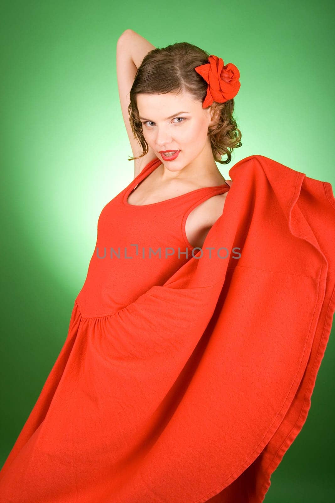 beautiful girl in red dress over green background
