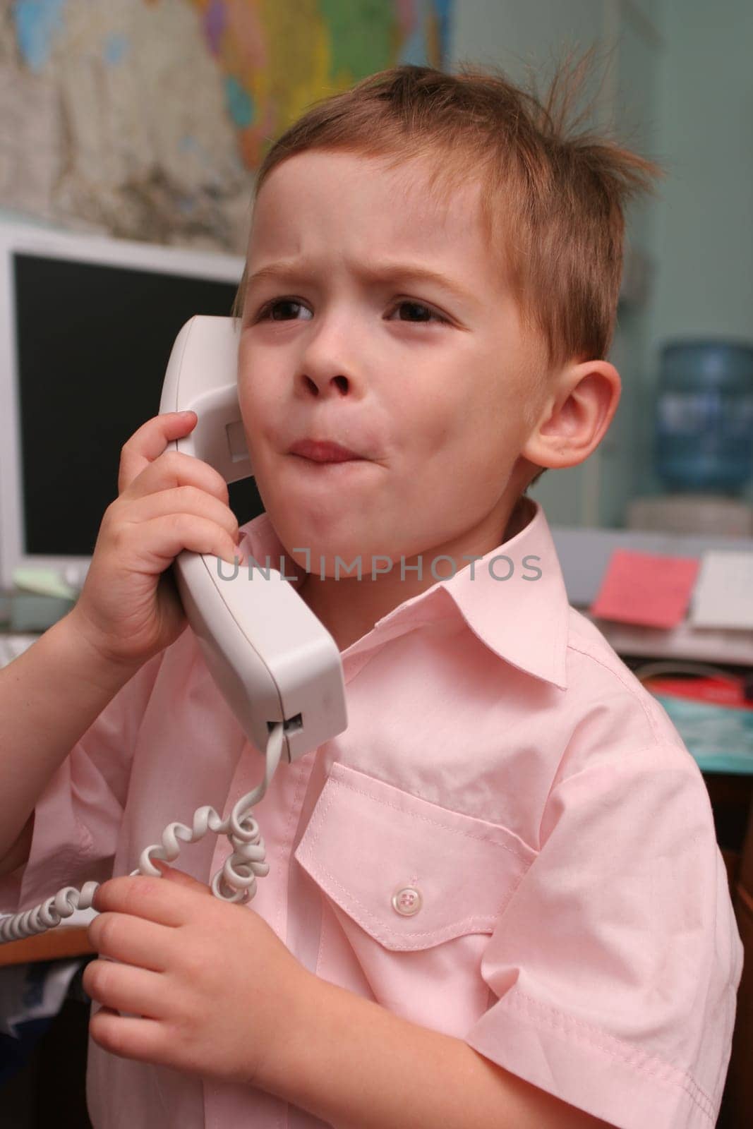 The boy speaks by phone in working hours