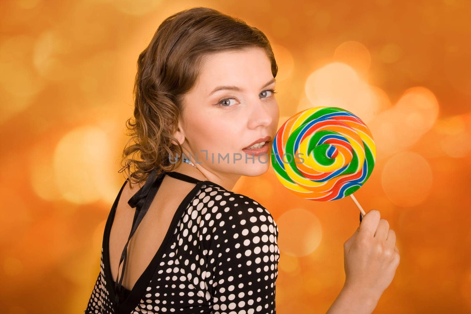 fashion girl with a rainbow lollipop