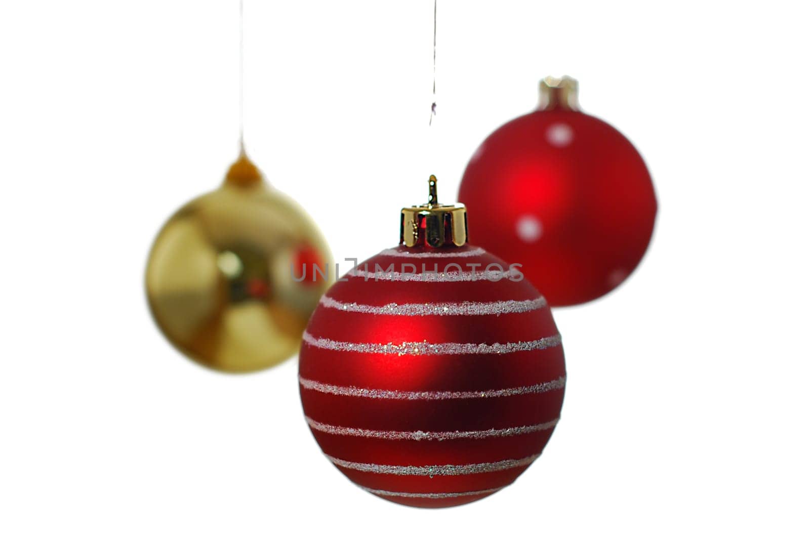 Three hanging Christmas baubles isolated on a white background