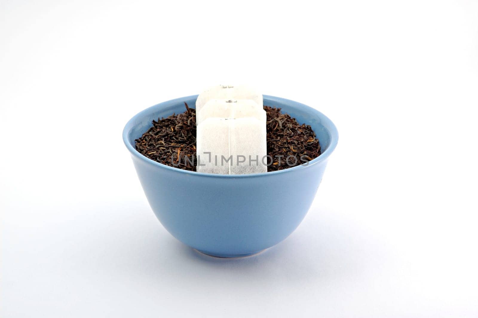 Tea leafs and bags in blue bowl