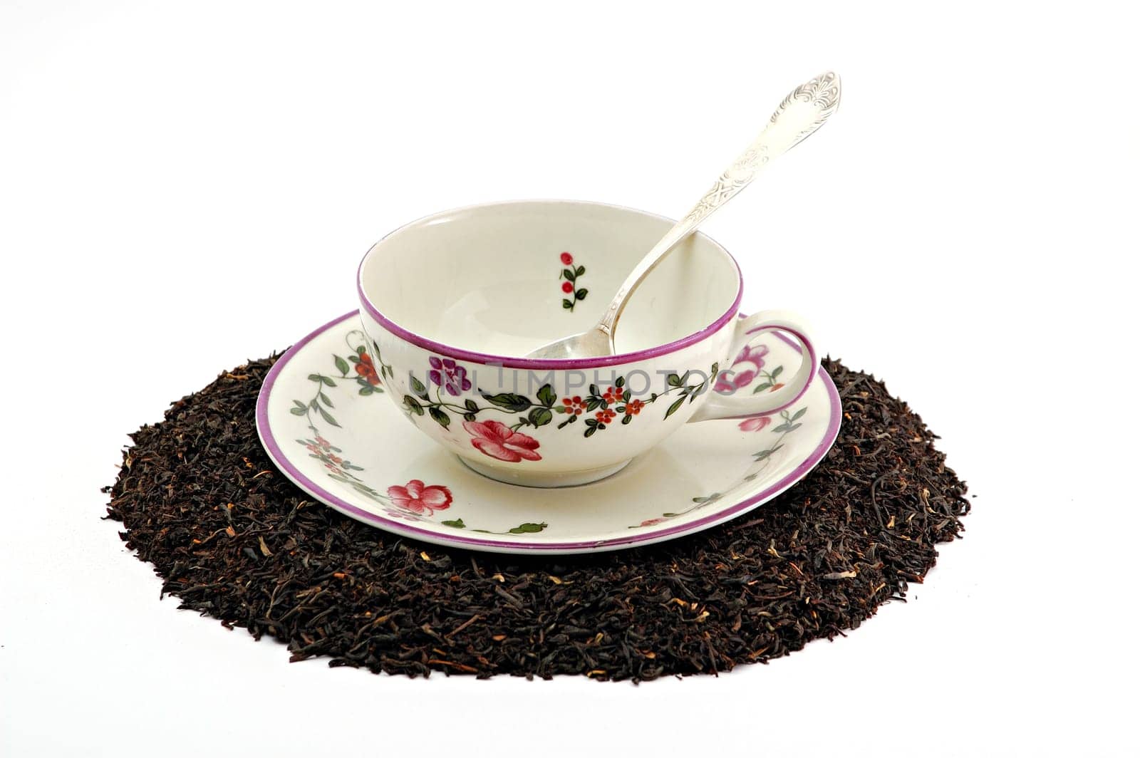 Tea cup on scattered tea leafs