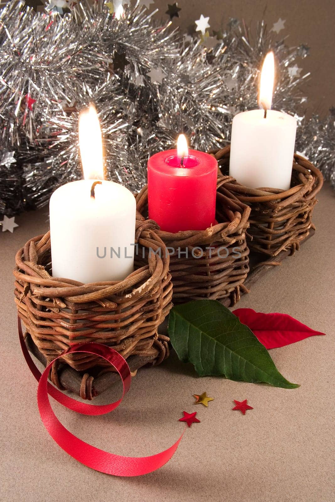 3 candles with christmas ornaments