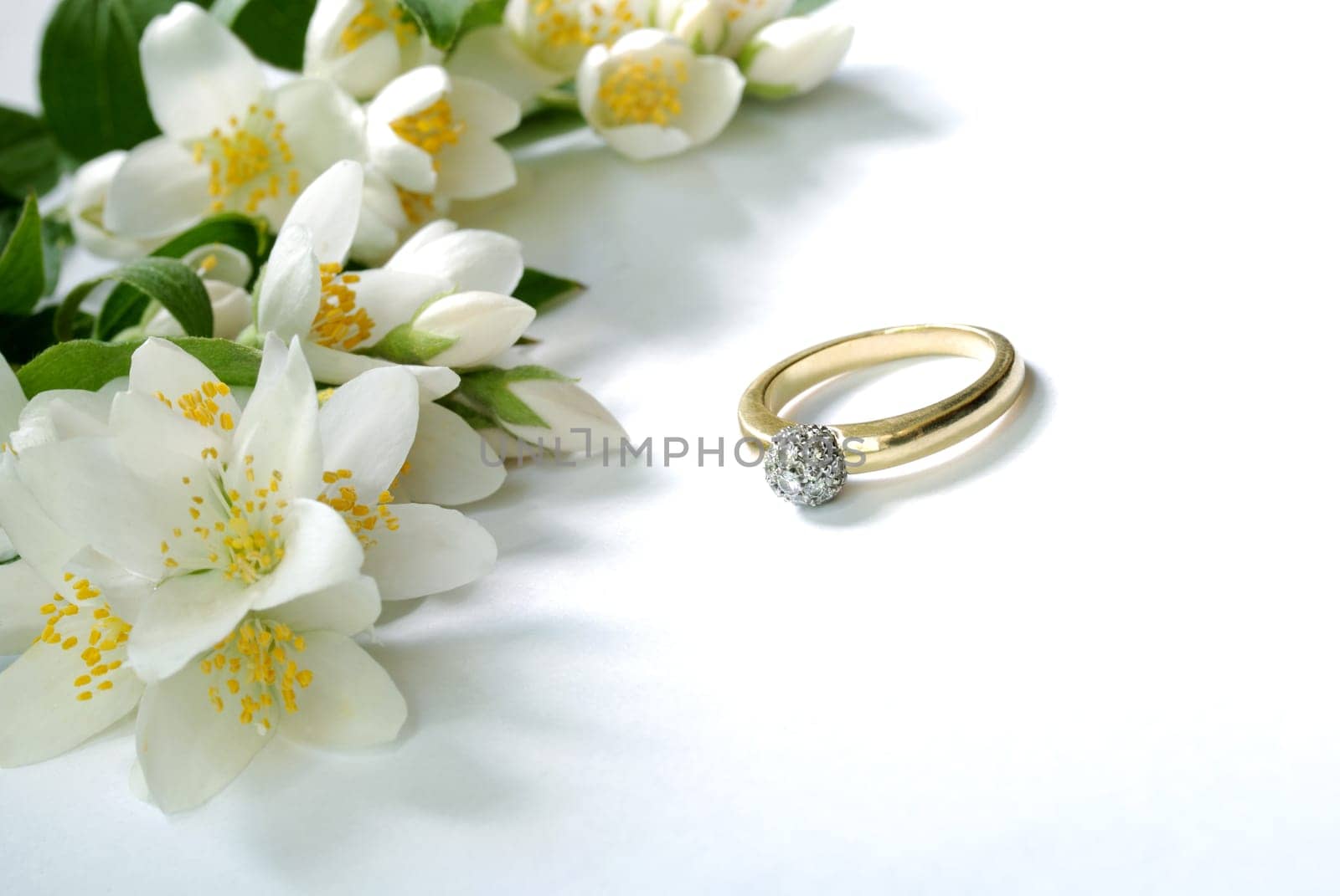 gold ring and jasmin flowers