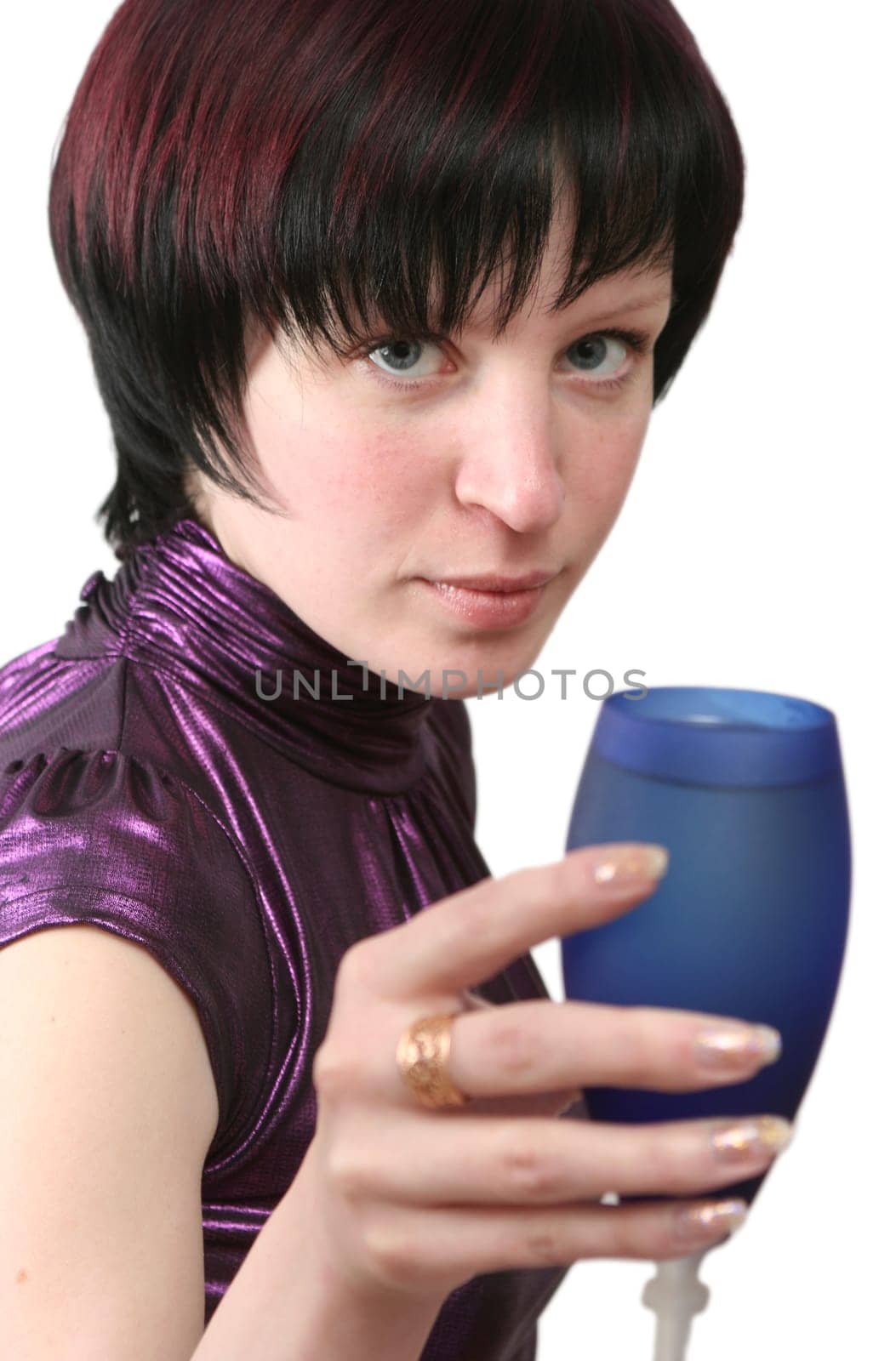 Eyes of the girl which are held in hands with a dark blue glass