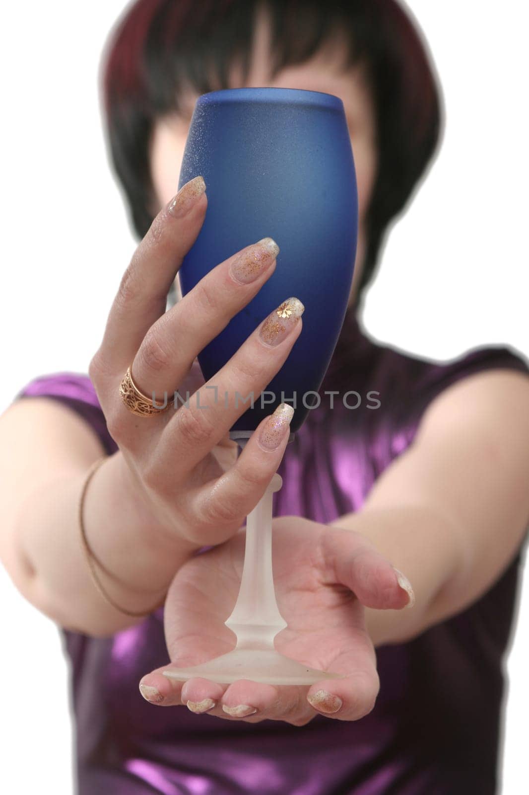 Dark blue glass with wine in female hands