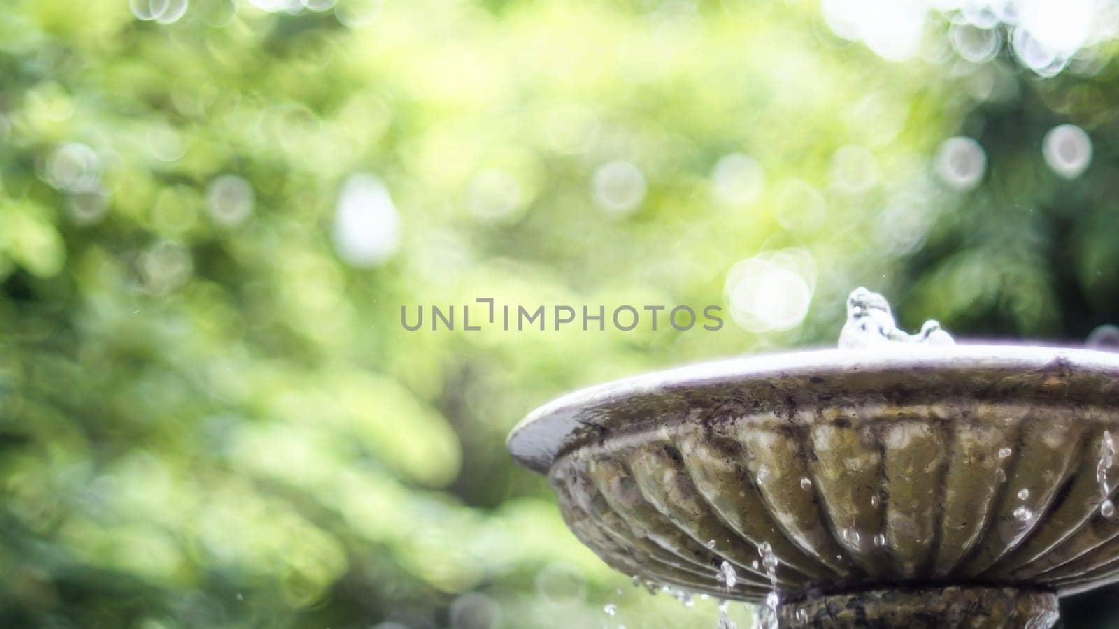 Antique fountain at garden. Water flowing from stone fountain. Design of antique fountain .calm and peacefulness concept idea
