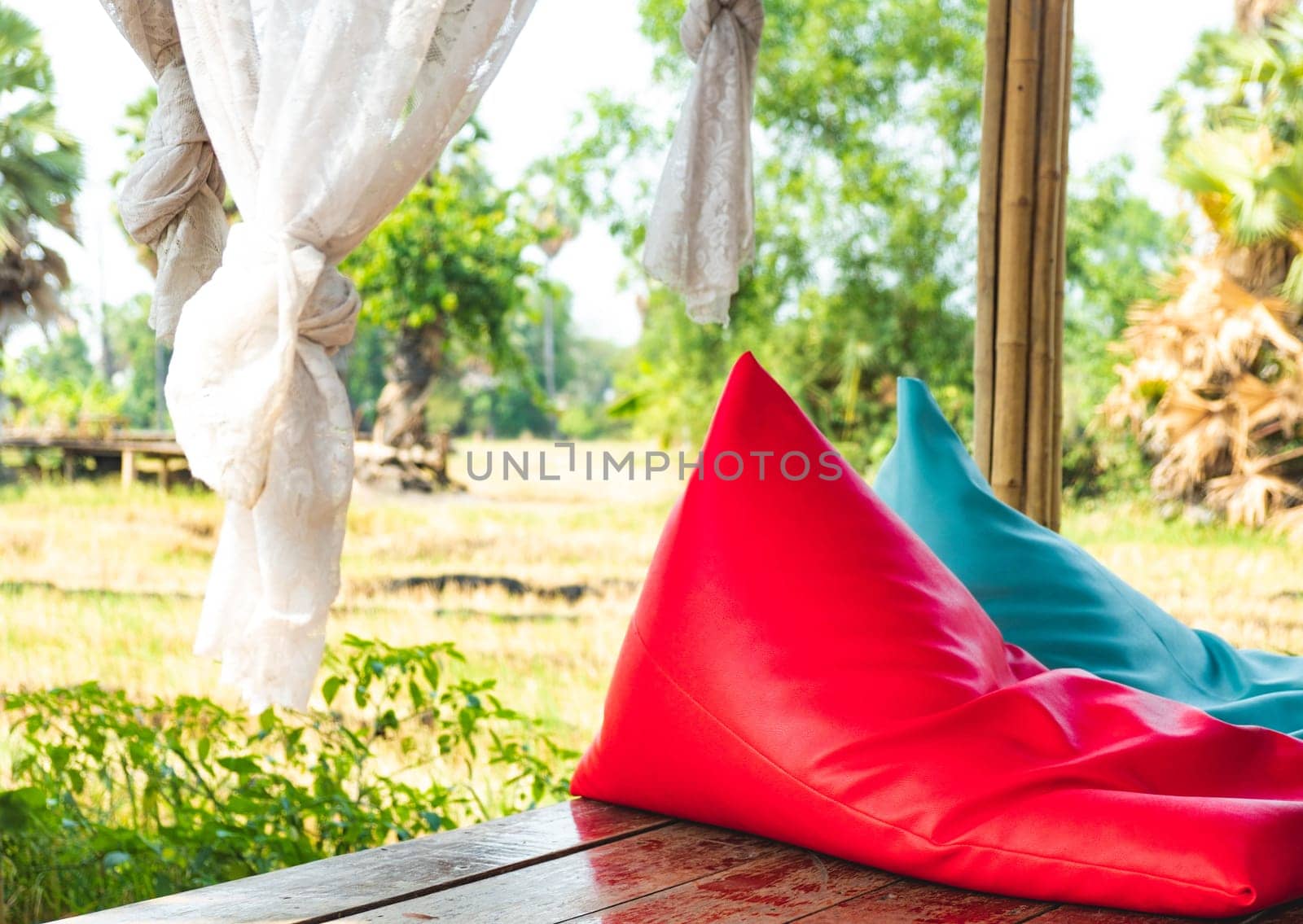 Colorful bean bags seat furniture outdoor are decorated in garden asia style resort lanscape.