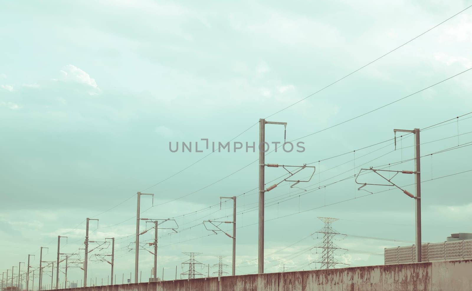 Street electricity poles  aligned  on the road with beautiful blue sky in background