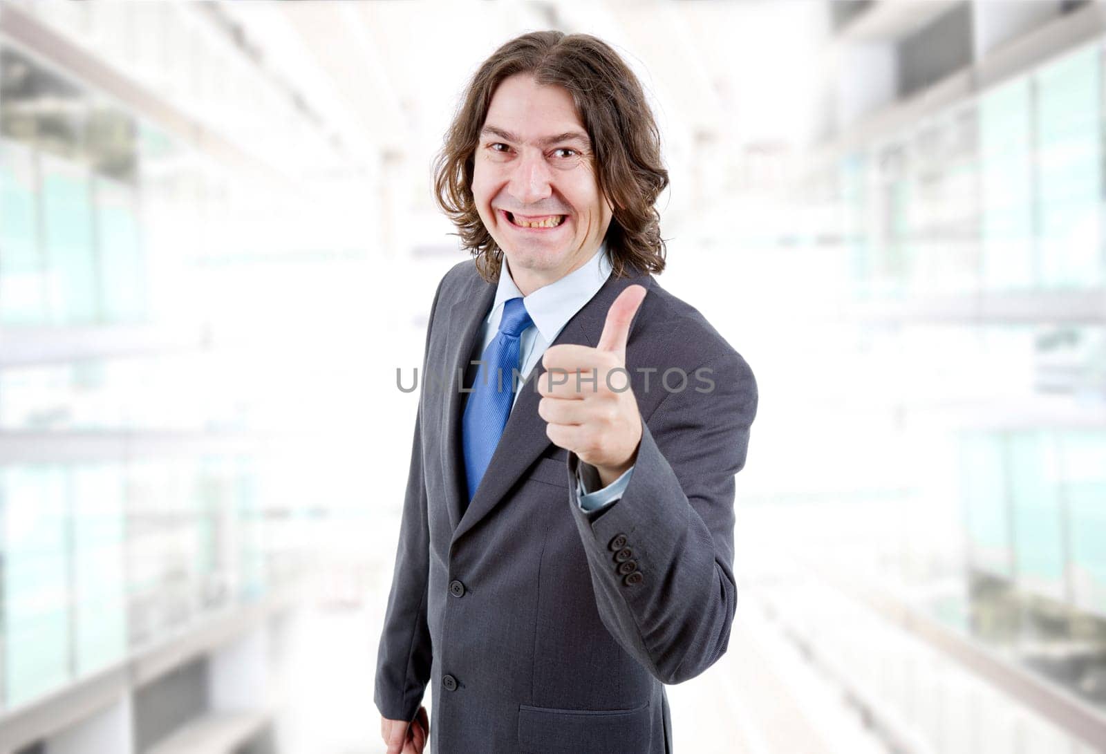 young business man going thumb up at the office