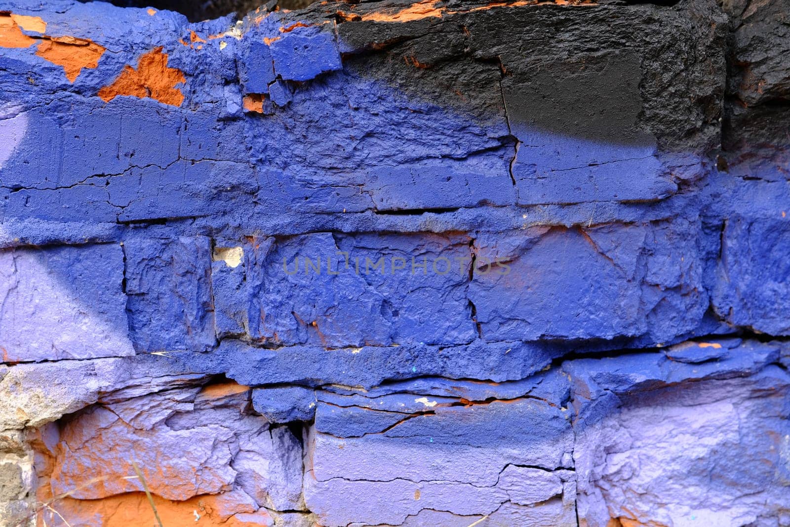 Colorful wall background with damaged paints of blue.