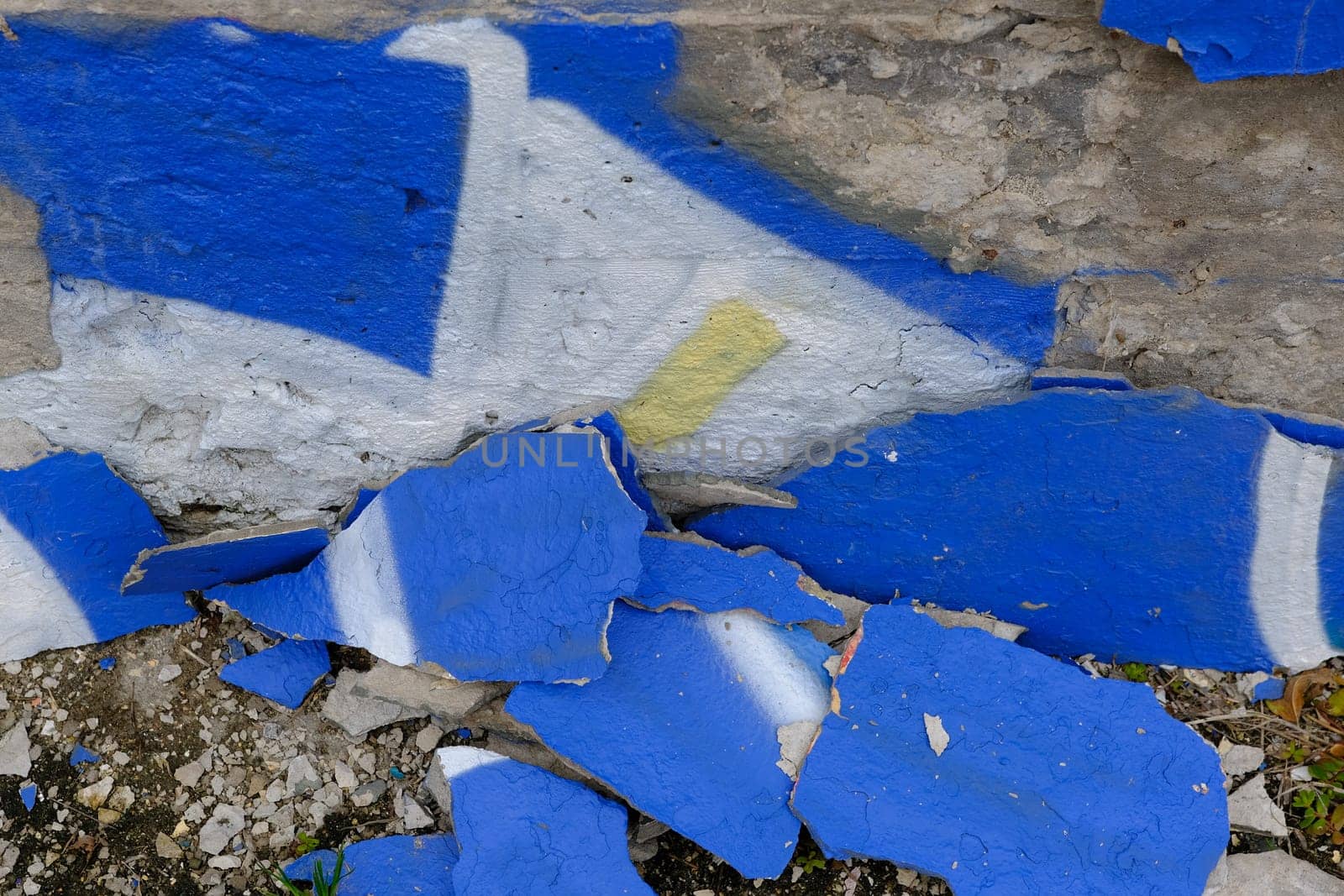 Colorful wall background with damaged paints of blue.