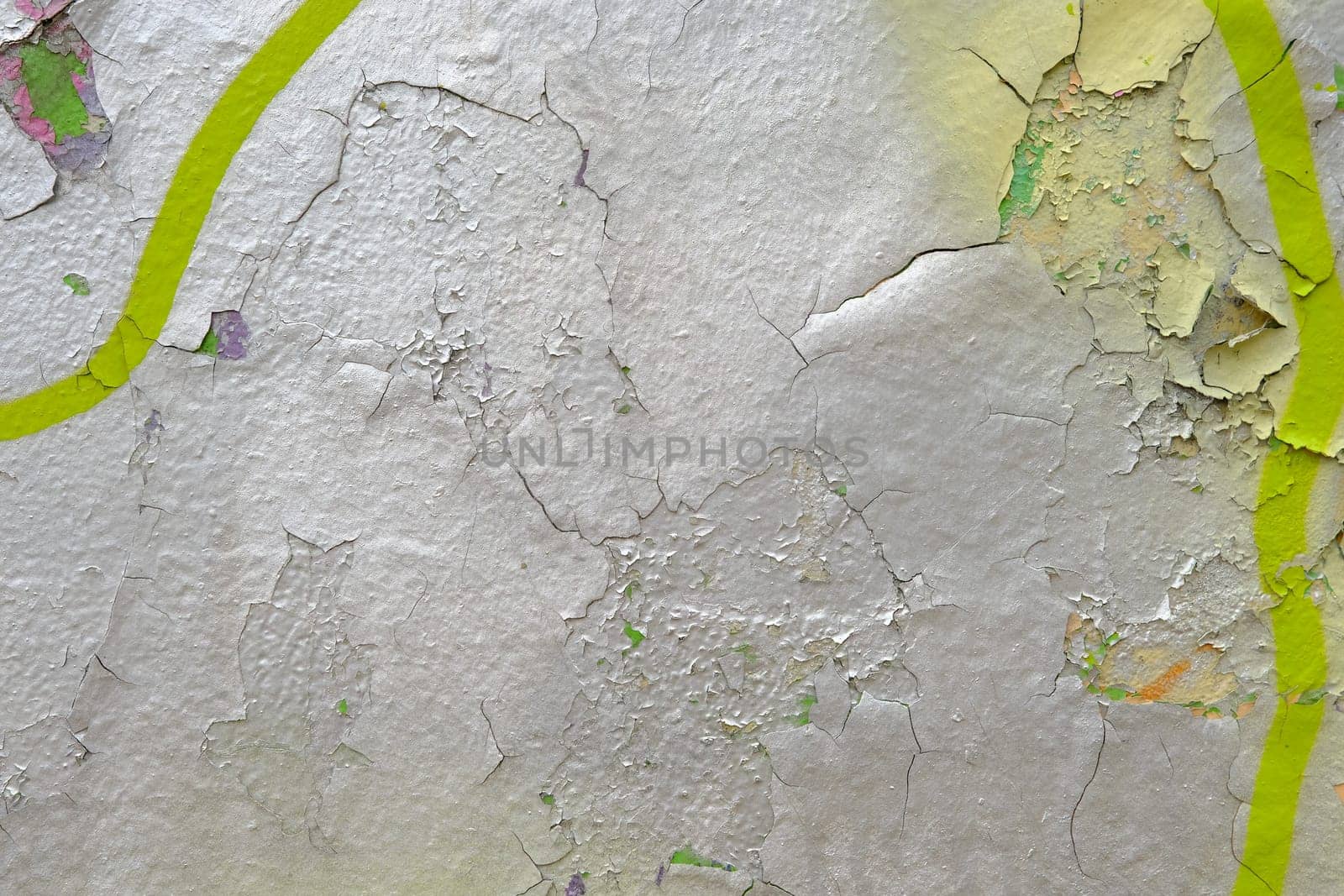 Colorful wall background with damaged paints of gray silver and yellow.