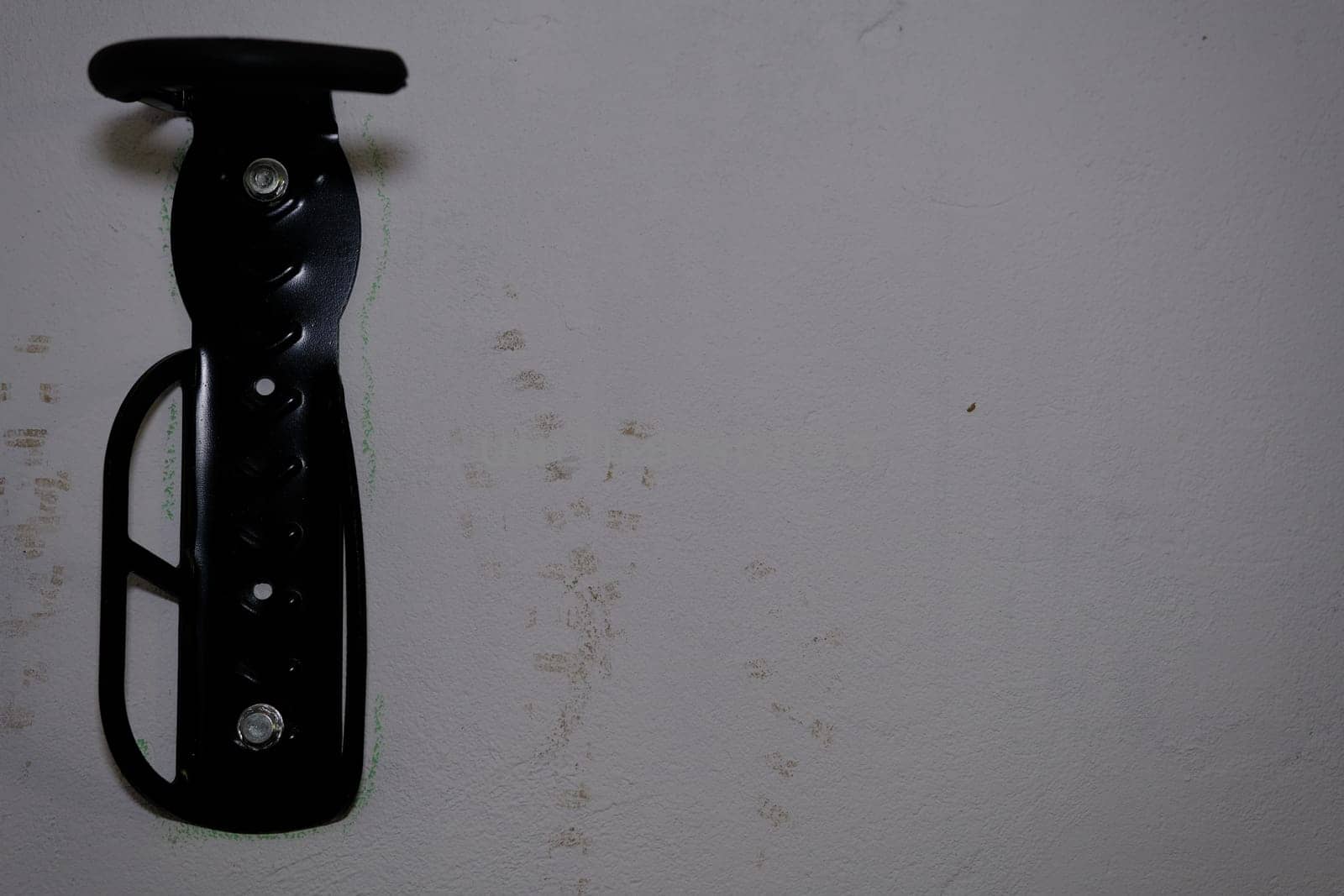 Bicycle tire hook clamp on the wall.
