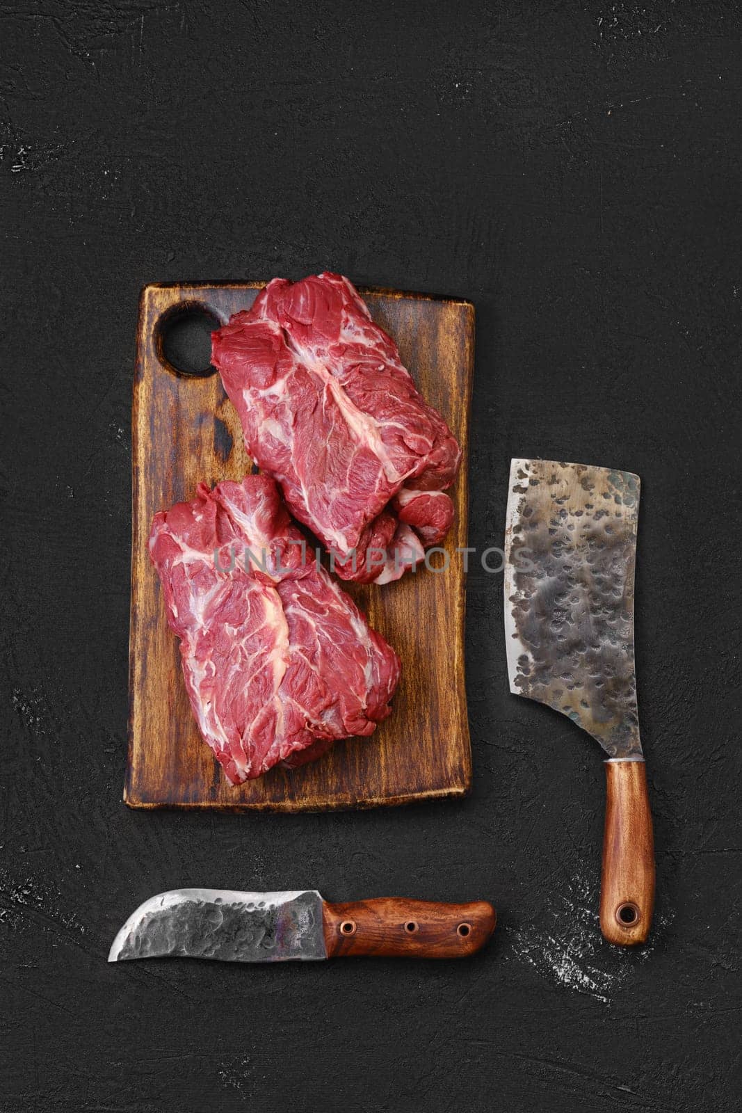 Overhead view of raw fresh lamb boneless neck meat on cutting board