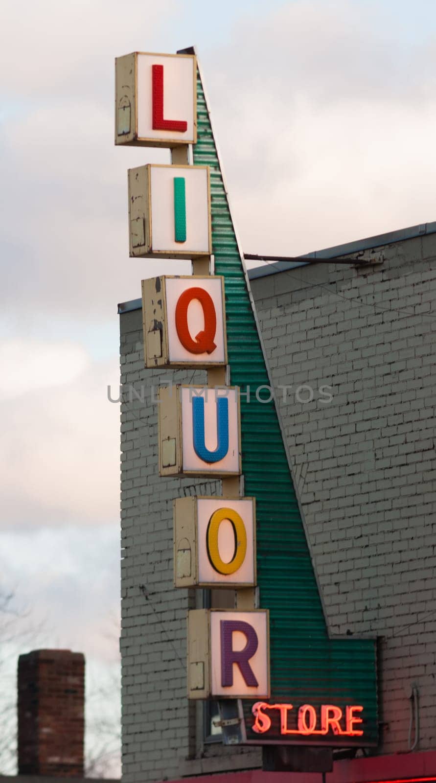 Vertical Liquor Store Sign Brick Wall Outside Advertisement