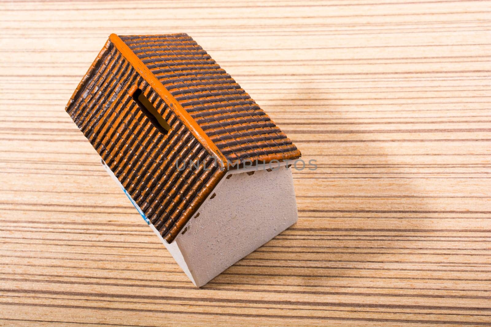 Little model house  and on a parquet background