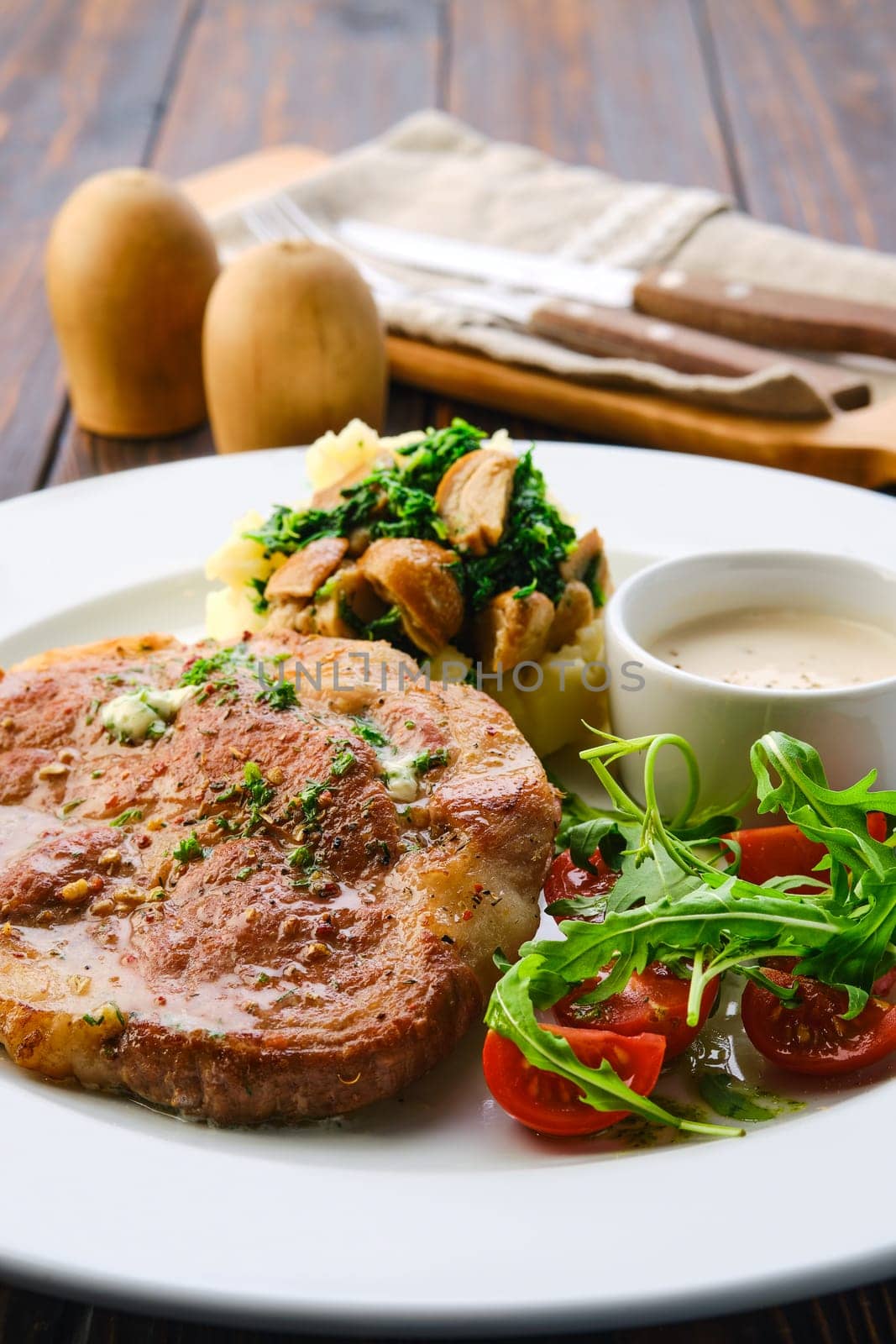 Plate with fried pork meat, mashed potato, mushrooms and tomato