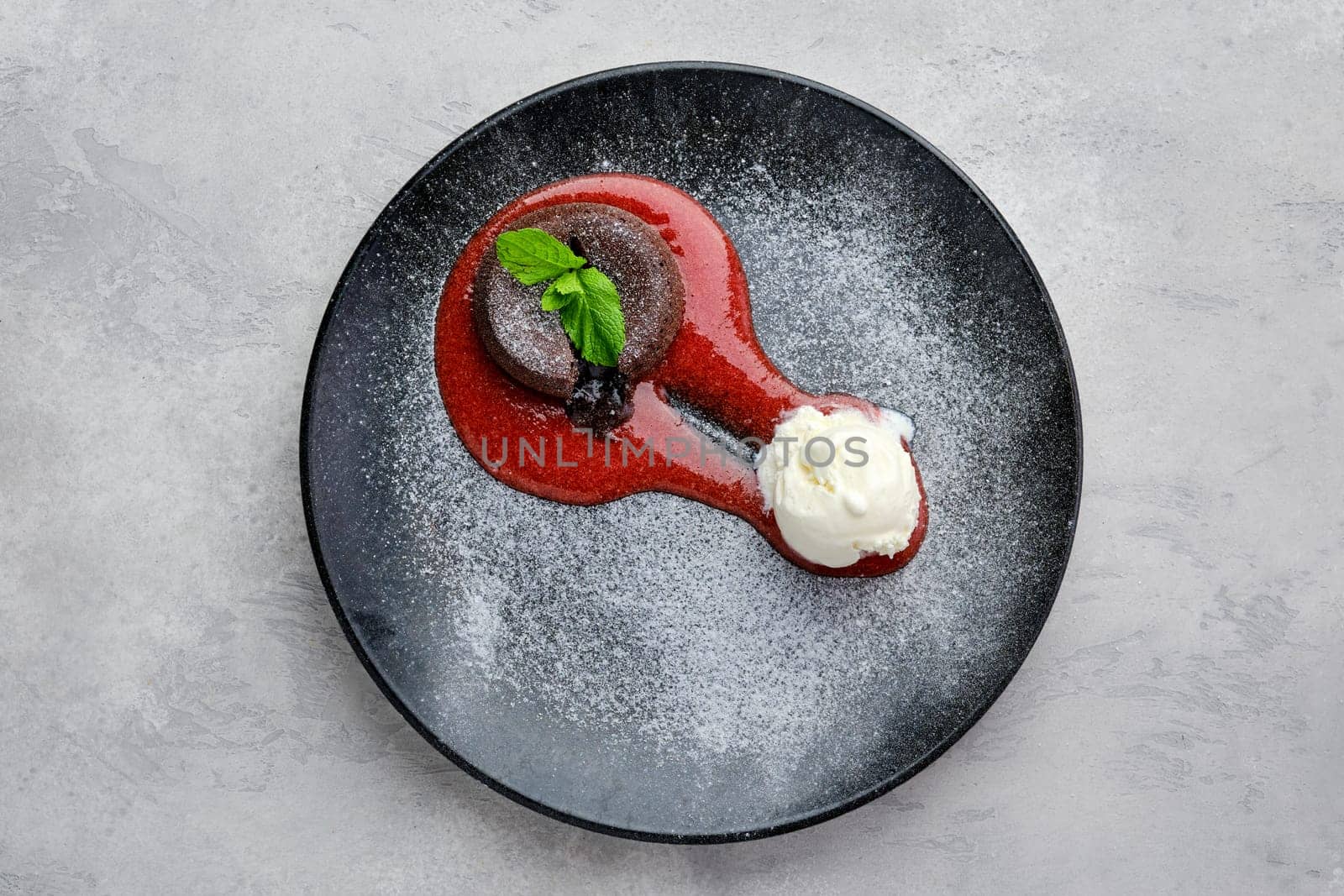 Top view of classic chocolate fondant with ice cream on a plate