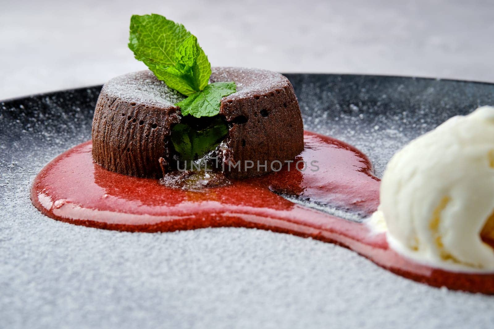 Closeup view of classic chocolate fondant with ice cream on a plate