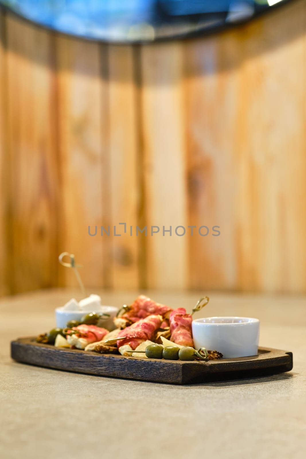 Plate with snack for wine (soft focus photo with shallow depth of field)