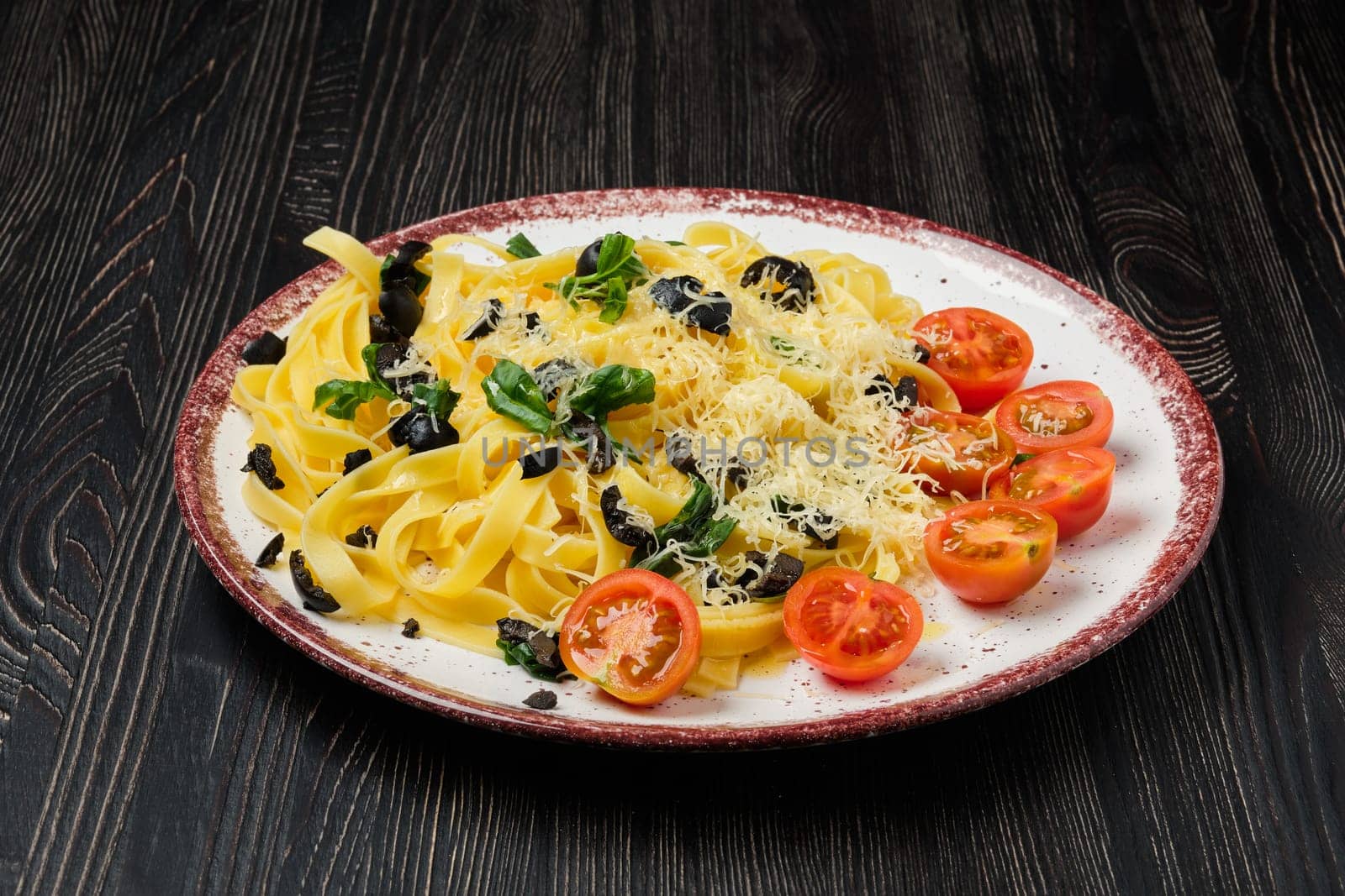 Tagliatelle with tomato, parmesan, chopped olives and basil