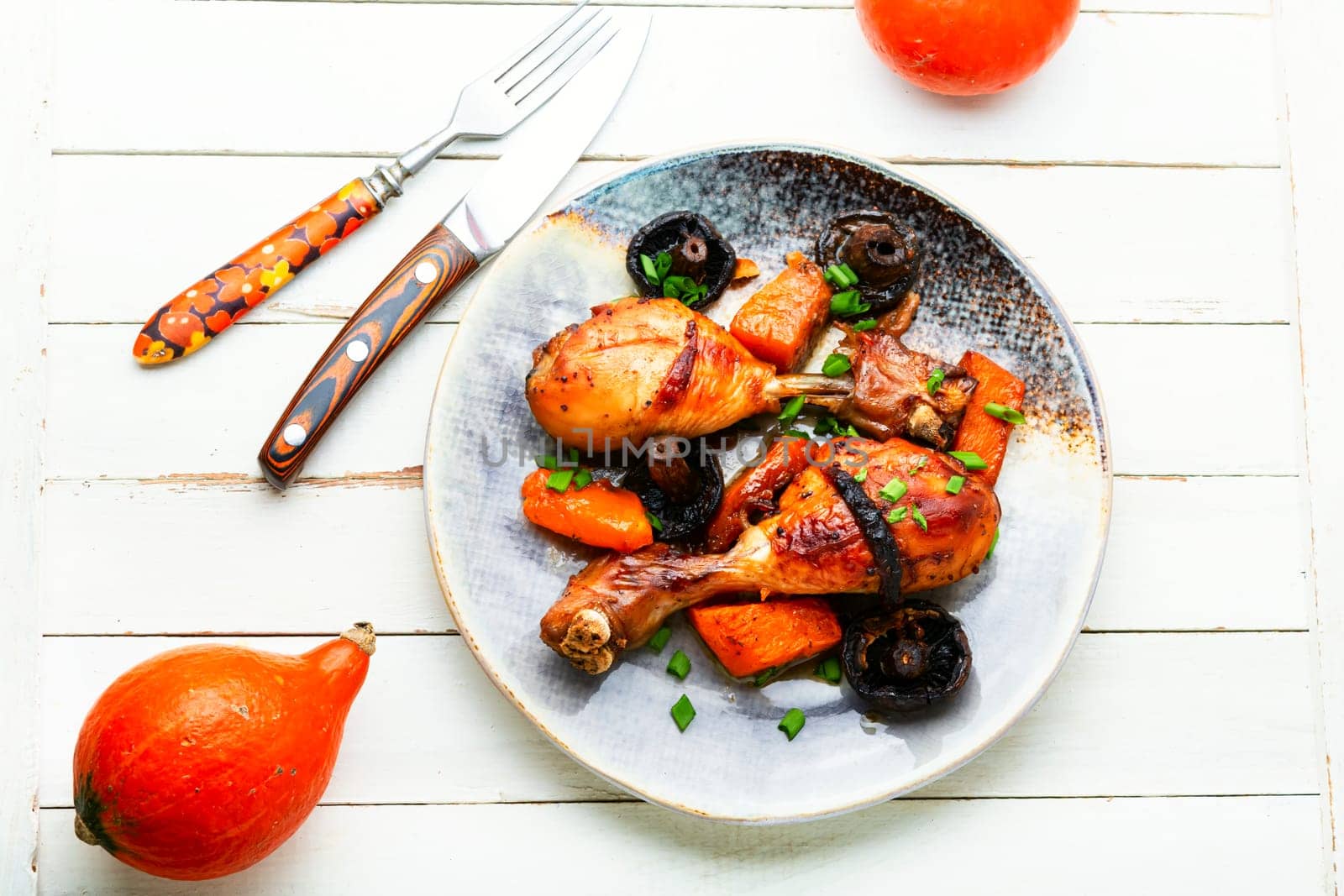 Chicken marinated meat in ginger sauce. Chicken legs fried with pumpkin and mushrooms. Food background