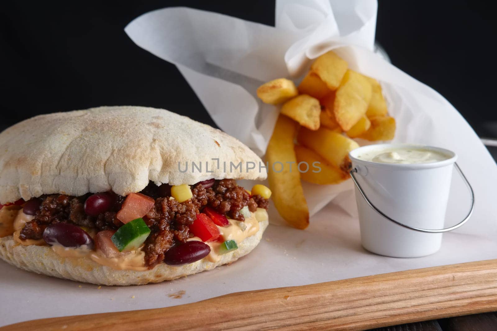 Pita bread with fried stuffing, beans and vegetables served with fried potato