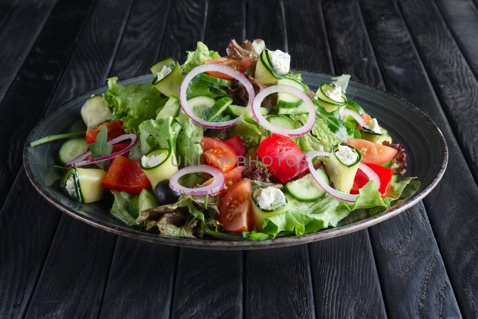 Salad with fresh cucumber, tomato, bell pepper, feta and onion
