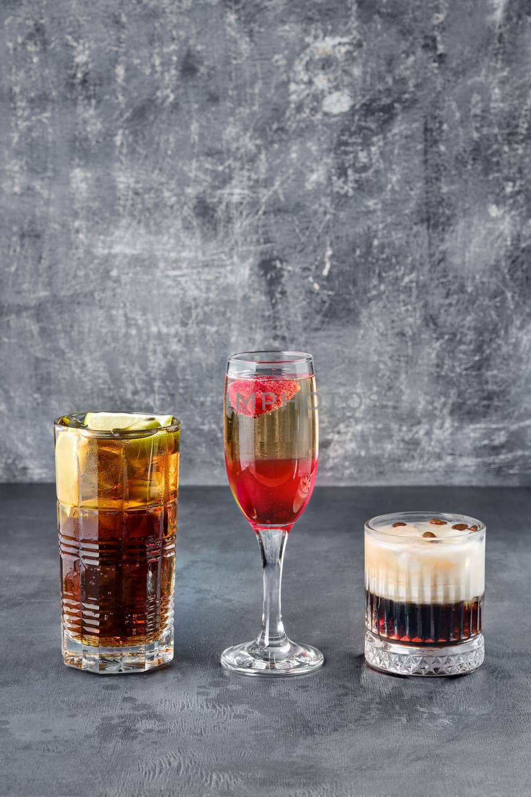 Party cocktails - cuba libre, whiskey sour and a sparkling wine with strawberry