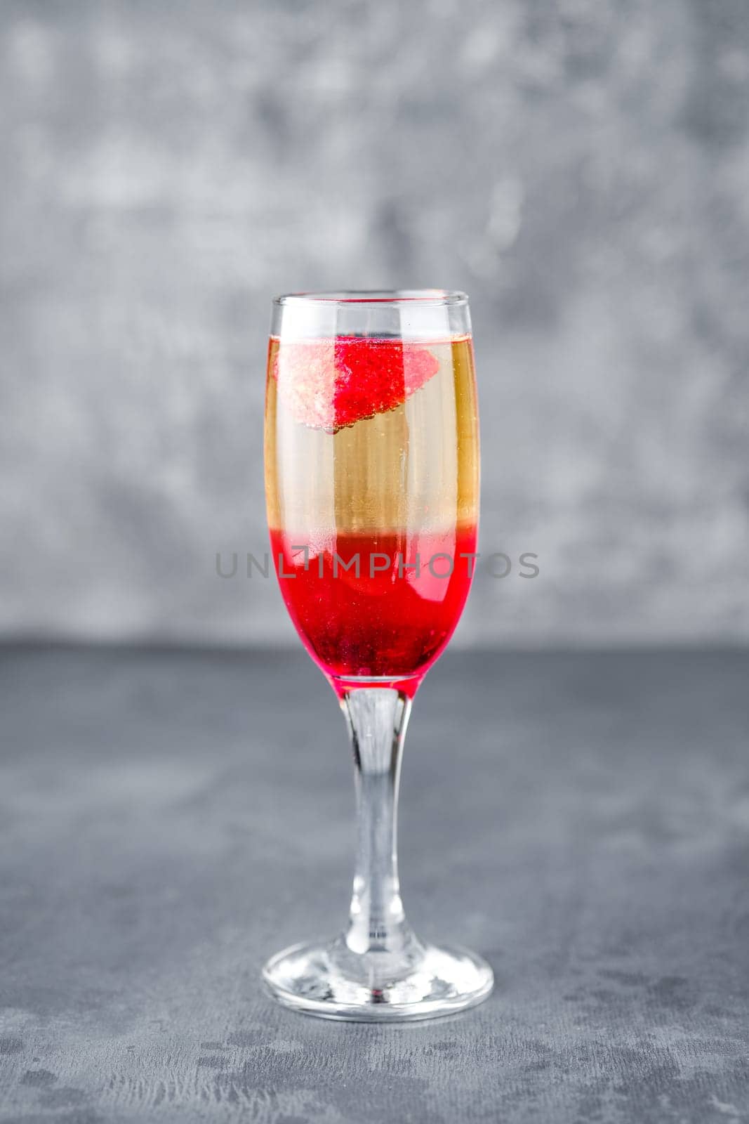 Strawberry cocktail with sparcling wine on gray shabby background