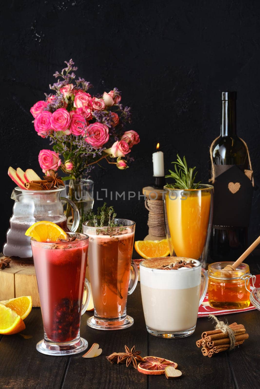 Composition with herbal and fruit hot alcohol drinks with ingredients on the table