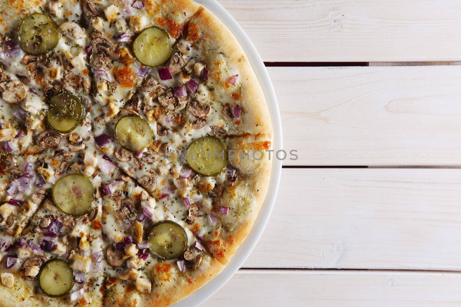 Pizza with onion, mushrooms and pickled cucumber