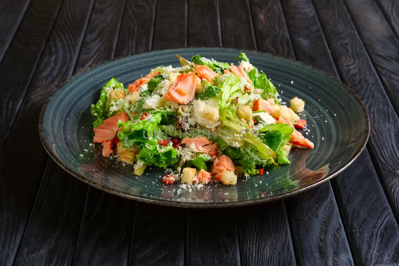 Plate with smoked salmon salad with chips, shrimps and cheese