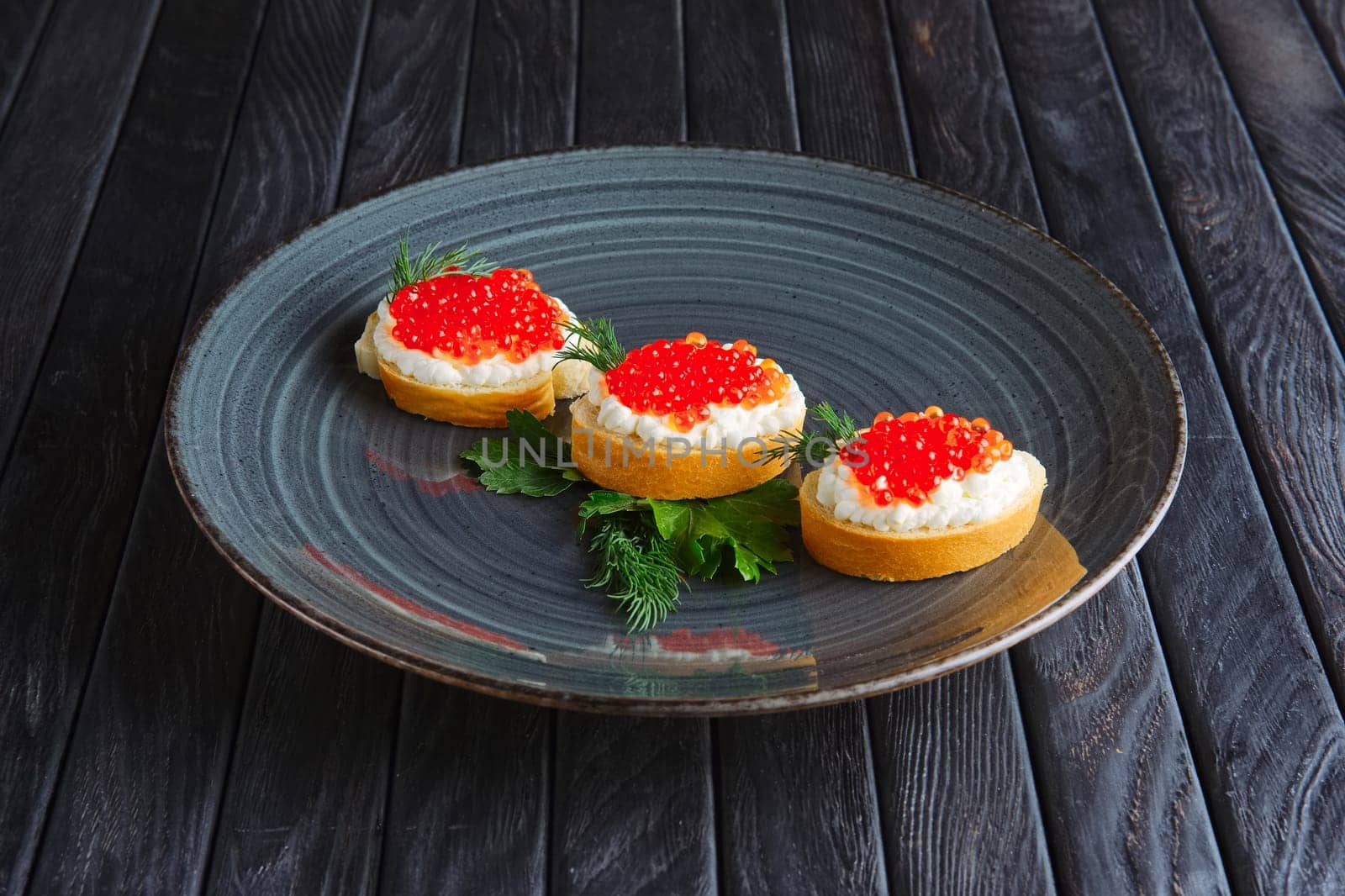 Appetizer for reception. Baguette, bread and butter with ricotta and salmon caviar