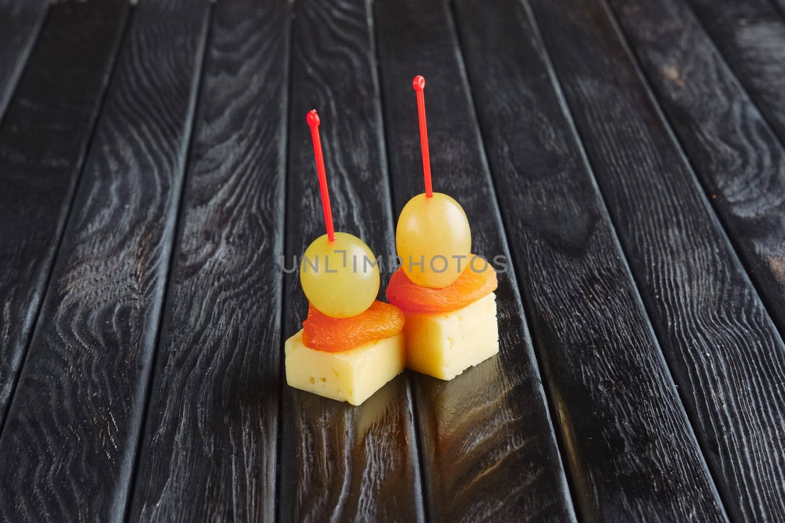 Appetizer for reception.  Cheese, dried apricot and grape on skewer