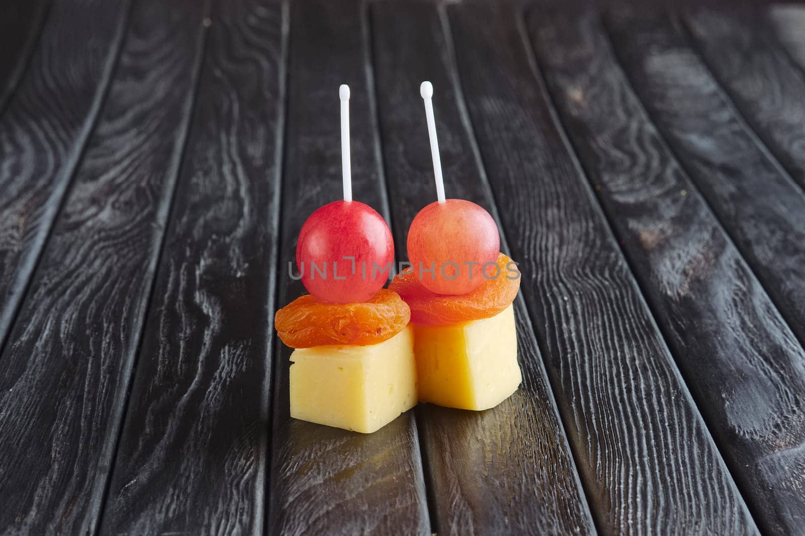 Appetizer for reception.  Cheese, dried apricot and grape on skewer