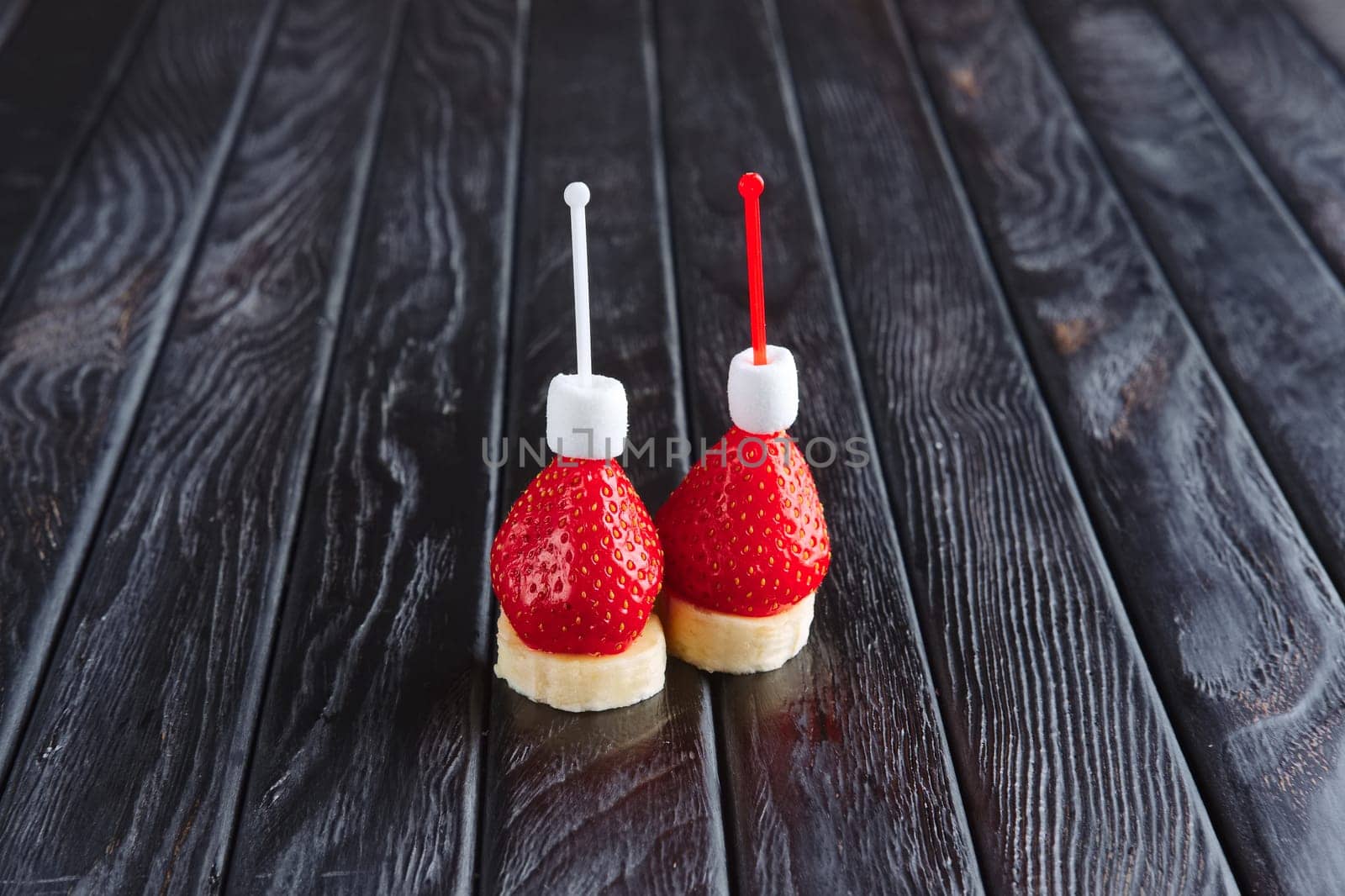 Appetizer for reception. Fresh banana with strawberry and small marshmallows on skewer